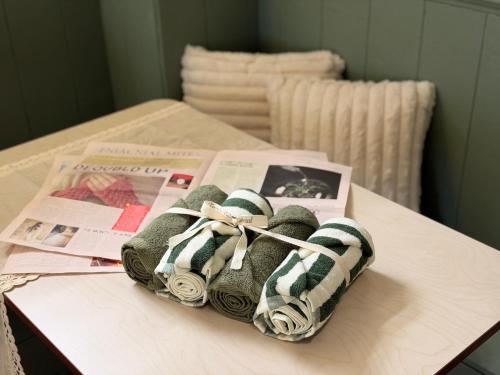 a pair of shoes on a table with a newspaper at Casa olive 까사올리브 in Millak-tong