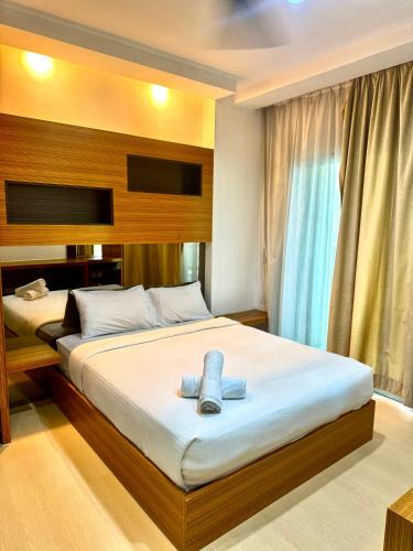 a bedroom with two beds and a window at Parkview Suites Near By Klcc in Kuala Lumpur