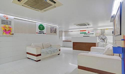a hospital room with a chair and a table at Treebo Cherry Tree in Indore
