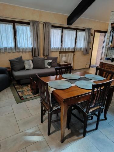 a living room with a wooden table and chairs at Appartamento Luigia House in Cornaredo