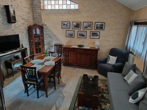 a living room with a table and a couch at Appartamento Luigia House in Cornaredo