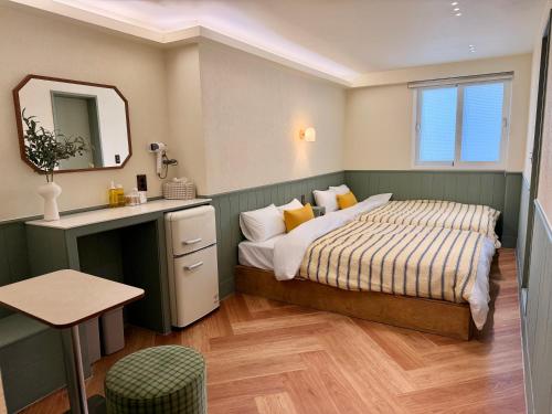 a bedroom with a bed and a sink and a mirror at Casa olive 까사올리브 in Millak-tong