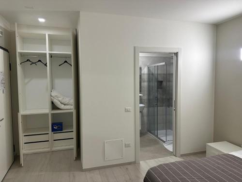 a bedroom with a bed and a walk in closet at Locanda Patoea Alloggi in Borgoricco