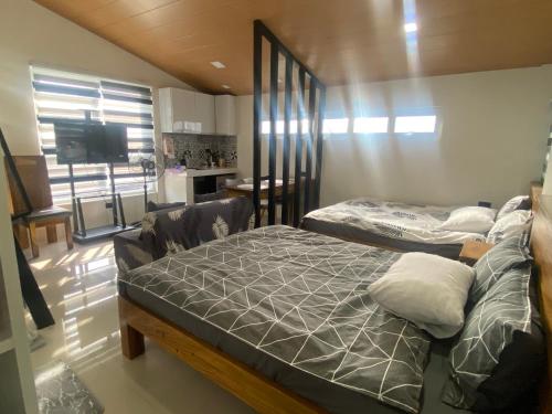 a bedroom with two beds and a living room at Balai Mi Vigan in Vigan