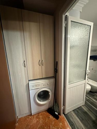 a washer and dryer in a room with a bathroom at apartament gezuar in Golem