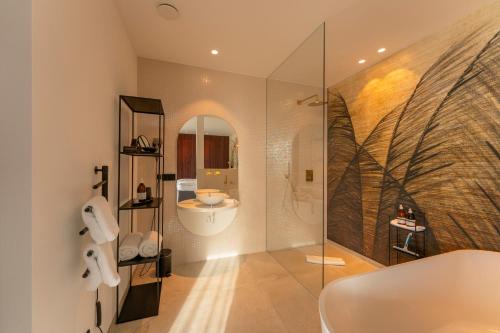 a bathroom with a shower and a sink and a toilet at ORANGE LOUNGE Attersee in Weyregg