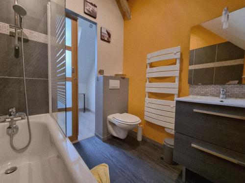 a bathroom with a tub and a toilet and a sink at Chambres d'Hôtes du Paillé in Thenay