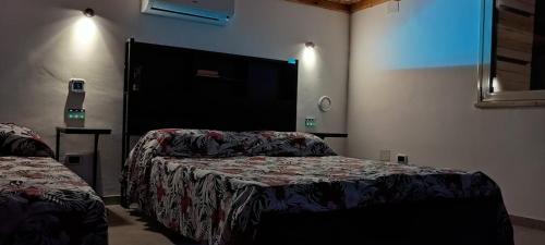 a hotel room with two beds and a mirror at Chalet Gallipoli in Gallipoli