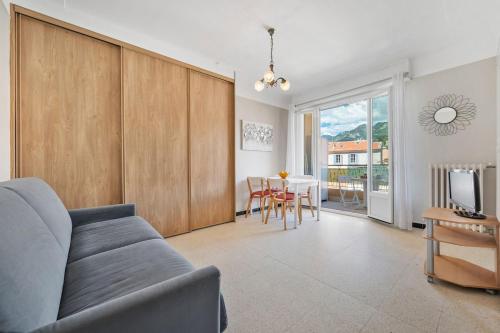 a living room with a couch and a dining room at LE FELIX FAURE - Hyper Centre - Terrasse - Plages in Menton