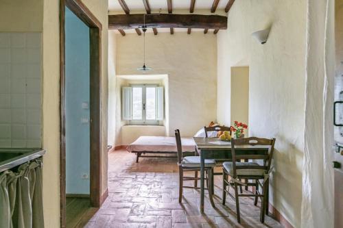 a kitchen and dining room with a table and chairs at Villa Toscanna in Pelago