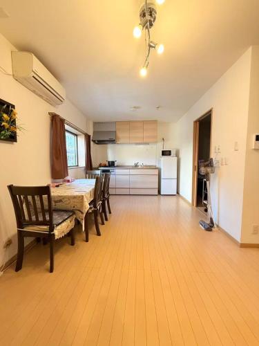 a kitchen and dining room with a table and chairs at 十五夜 in Osaka