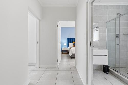 a white bathroom with a shower and a sink at Ballito Hills 171 in Ballito