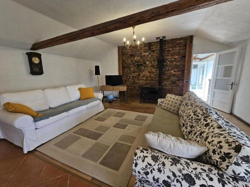 a living room with a couch and a table at Guest House Luca in Galda de Jos