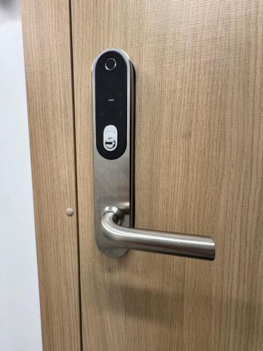 a metal door handle on a wooden door at Kaunas City Center Apartment in Kaunas