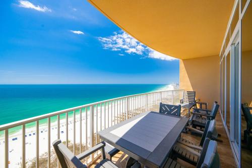a balcony with a table and chairs and the ocean at Phoenix Orange Beach II 2103 in Orange Beach