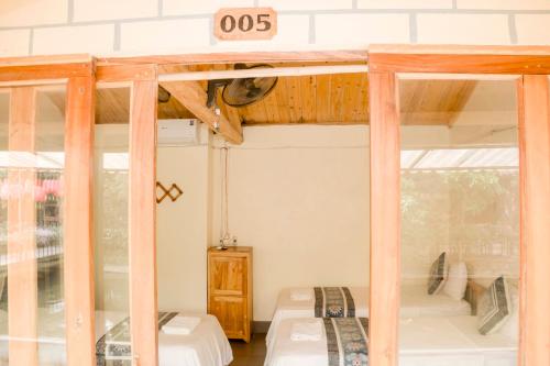 a room with two beds and a sign that reads at Bong Bang homestay 2 in Na Hang