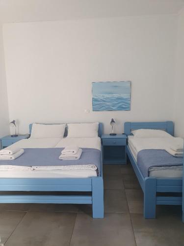 two beds sitting next to each other in a room at Babis & Popi Rooms and Studios in Frangokastello