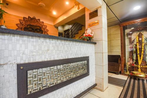 a store front with a brick wall and a window at Hotel Shakti Palace in Ponda