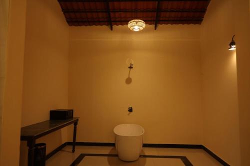 a room with a table and a trash can at Tuli Orchid - A Boutique Eco Resort in Rāmtek