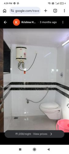 a bathroom with a white toilet in a window at zoz mount abu in Jāmb