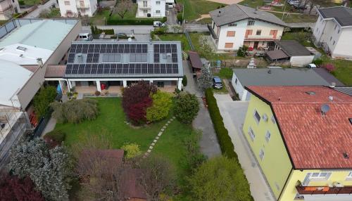 an aerial view of a house with solar panels on its yard at House Martina in Limana