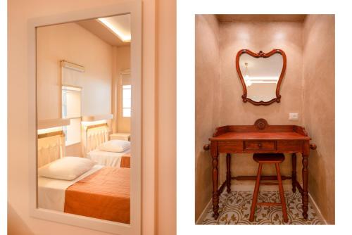 a room with a mirror and a table with a bed at Villa Kadith Agios Gordios in Agios Gordios