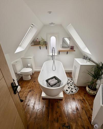 a bathroom with a bath tub and a toilet at FRESH Flat in Leek, Staffordshire in Leek