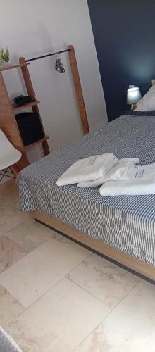 a bed in a room with a ladder next to it at Vesper Rooms in Skala Prinou