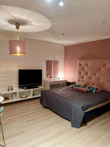 a bedroom with a bed and a flat screen tv at Apartament Blue Monte 60 in Sopot