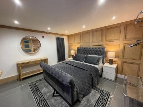 a bedroom with a large bed and a mirror at Hendham House - Near Etihad Stadium, CoOp Live Arena, AO Arena, Piccadilly Train Station & Manchester City Centre in Manchester