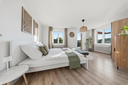 a white living room with a couch and a table at Napajedla in Znojmo
