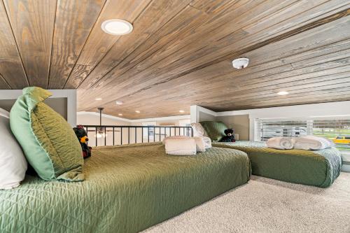 two beds in a room with a wooden ceiling at Pigeon Forge Landing RV Resort in Pigeon Forge