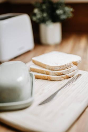 a stack of cookies sitting on a white plate with a knife at Room 2 at The Firs in Backwell