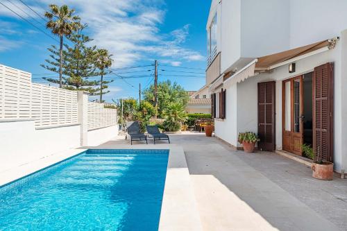 a swimming pool in the backyard of a house at Villa Magraner by Sealand Villas in Can Picafort