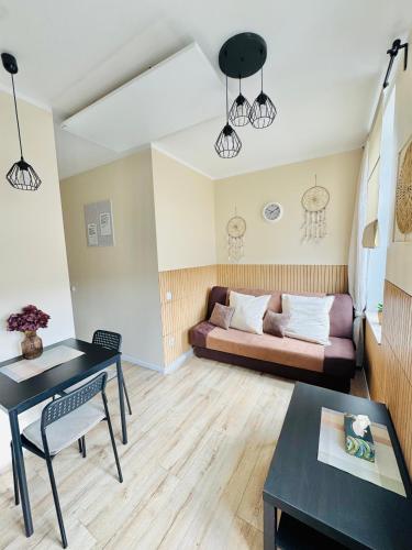 a living room with a couch and a table at Przy Parku Róż II in Chorzów