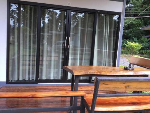 a screened in porch with a table and chairs at House at island Chang in Ban Map Khangkhao