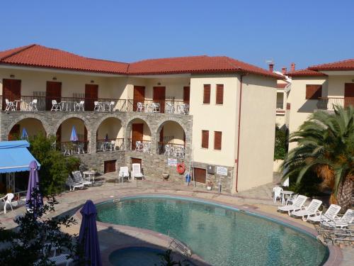 a swimming pool in front of a building at Hotel Argo in Siviri