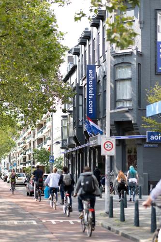 a group of people riding bikes down a city street at a&o Rotterdam City in Rotterdam