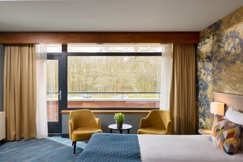 a hotel room with a bed and a window at Hotel van der Valk Wolvega-Heerenveen in Wolvega