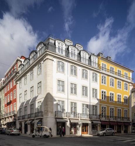 a large white building with cars parked in front of it at LSA Madalena by Numa in Lisbon
