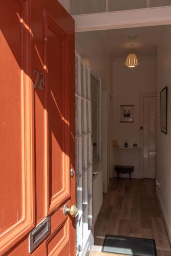 an open door to a hallway with a room at Beresford Cottage in North Berwick