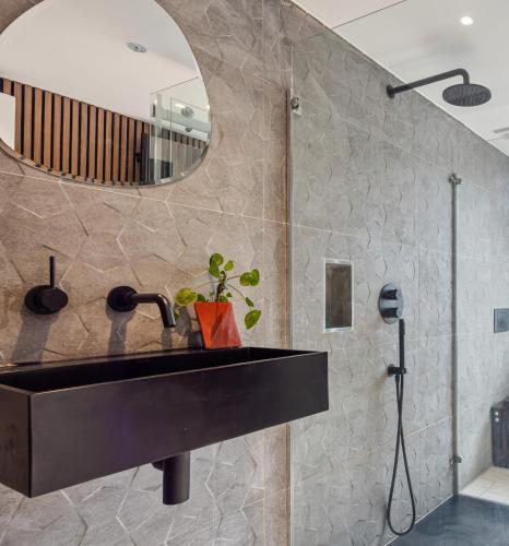 a bathroom with a black sink and a mirror at Central spacious town house in Exeter