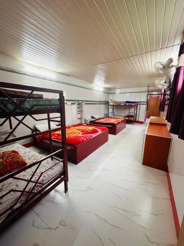 a room with three bunk beds in it at MSP Amma Cottage in Munnar