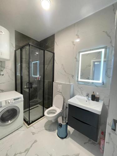 a bathroom with a shower toilet and a sink at Bliss by the Sea in Ulcinj