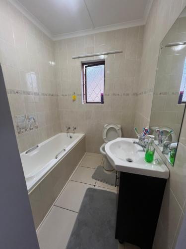 a bathroom with a sink and a tub and a toilet at Prime Leisure in Margate