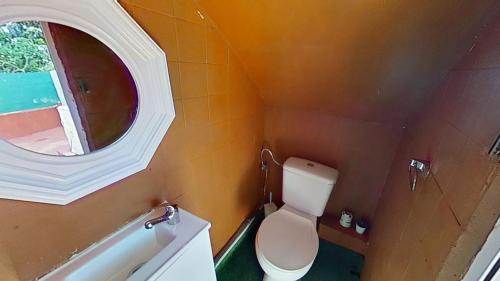 a small bathroom with a toilet and a mirror at Apartaments Segur Kandy 1 in Calafell