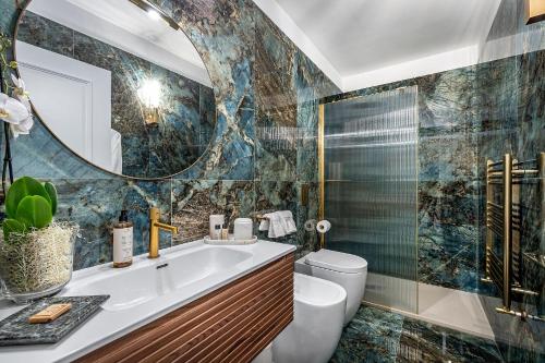 a bathroom with a sink and a toilet and a mirror at Gold Artè Collection in Florence