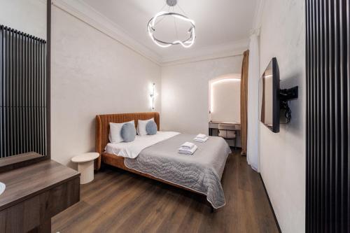 a small bedroom with a bed and a sink at Rynok Square Pidzemelya in Lviv