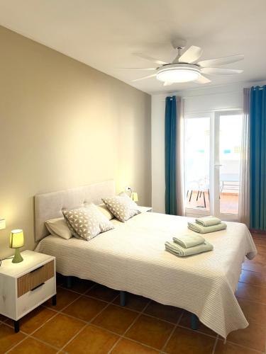 a bedroom with a large bed and a window at Heavenly Homes Mojacar 75 in Mojácar
