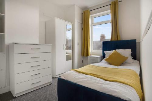 a bedroom with a bed and a dresser and a window at Freshly Renovated, Feels Like Home, Sleeps 3 in Chester-le-Street